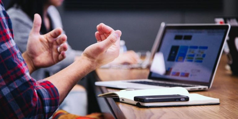 Man with gadgets and notebook discussing