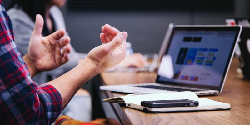 Man with gadgets and notebook discussing