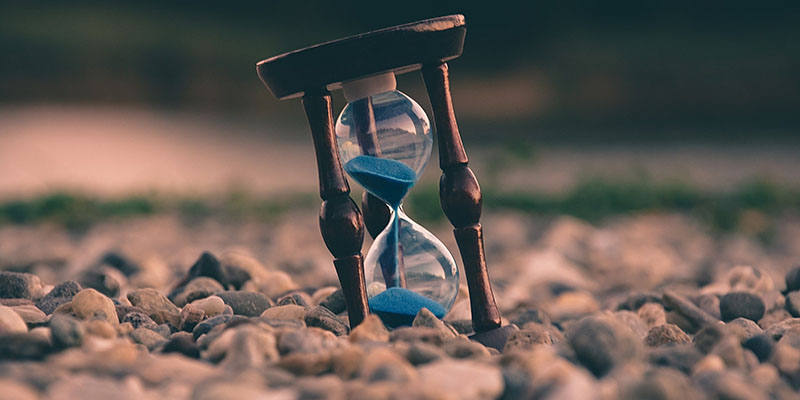 hourglass on gravel and sand