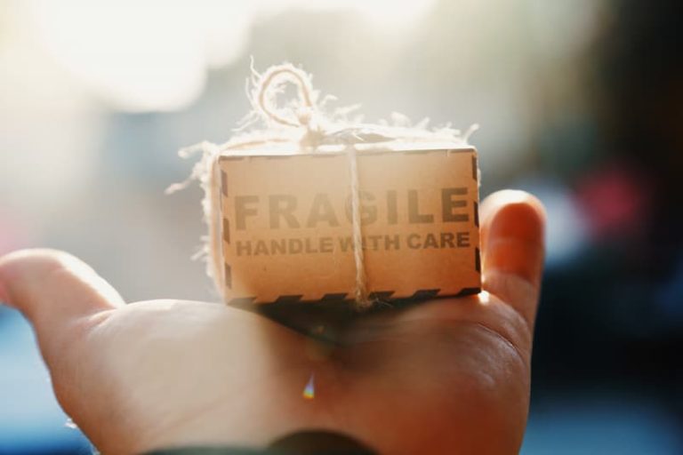 a hand holding a tiny box Feature Image For :How To Create A Long Term Beneficial Relationship With Your Customers