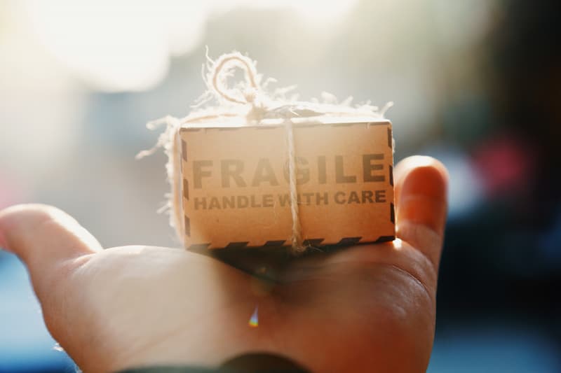 a hand holding a tiny box Feature Image For :How To Create A Long Term Beneficial Relationship With Your Customers