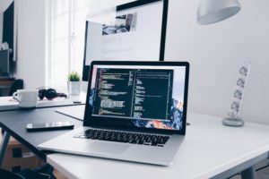 an open laptop on a desk with codes on the screen Feature Image For: 18 Best Tech Job Boards for Employers in Singapore